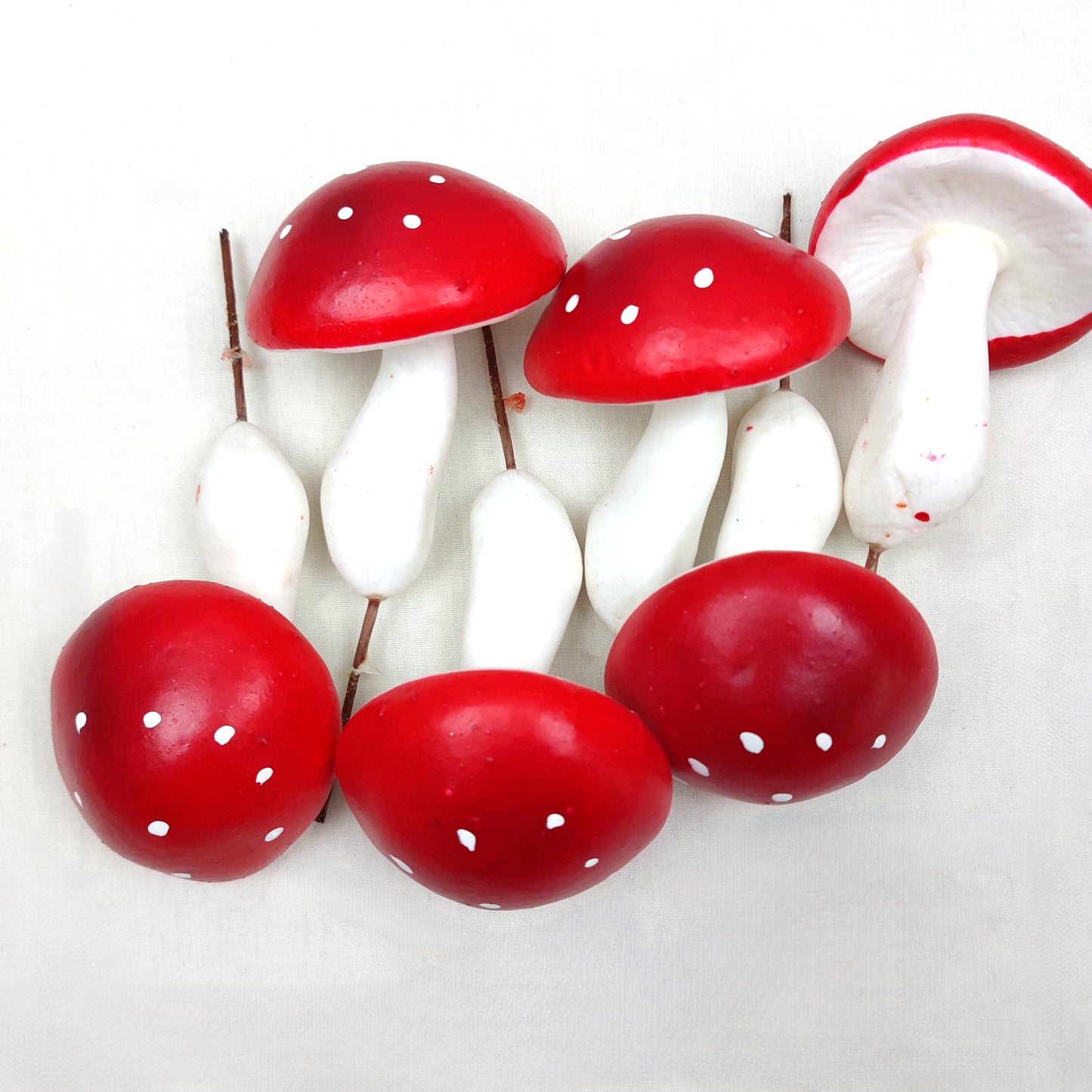 Artificial Red and white Mushrooms on a white background