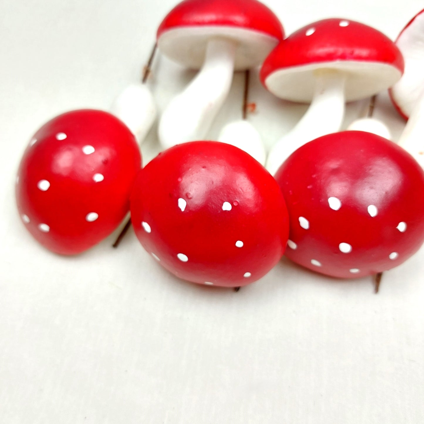 Fake Red Toadstools with white spots on a white background