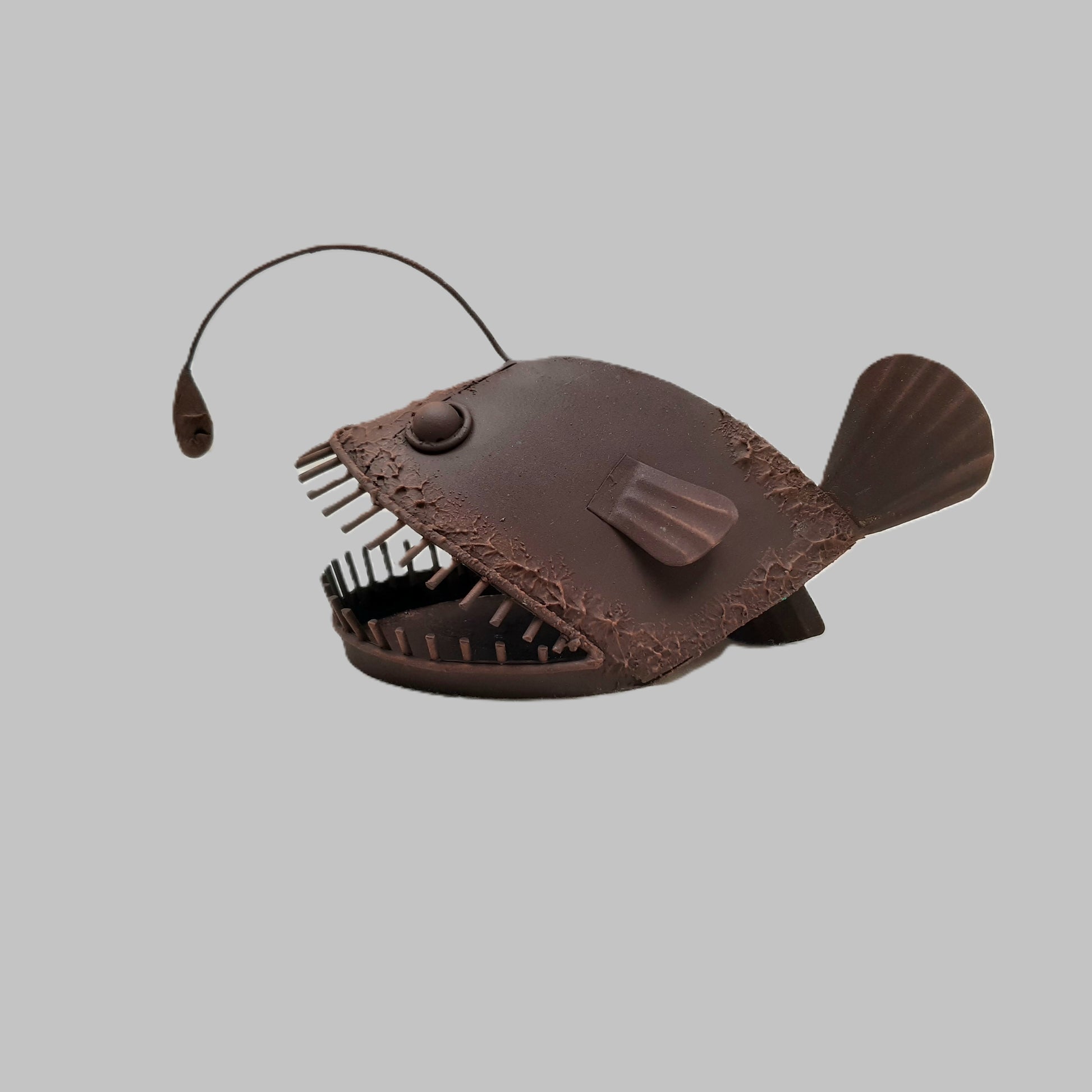 Horizontal post of a rust style angler fish ornament called Allan