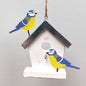 Decorative birdhouse wooden hanging decoration with painted birds on a plain background