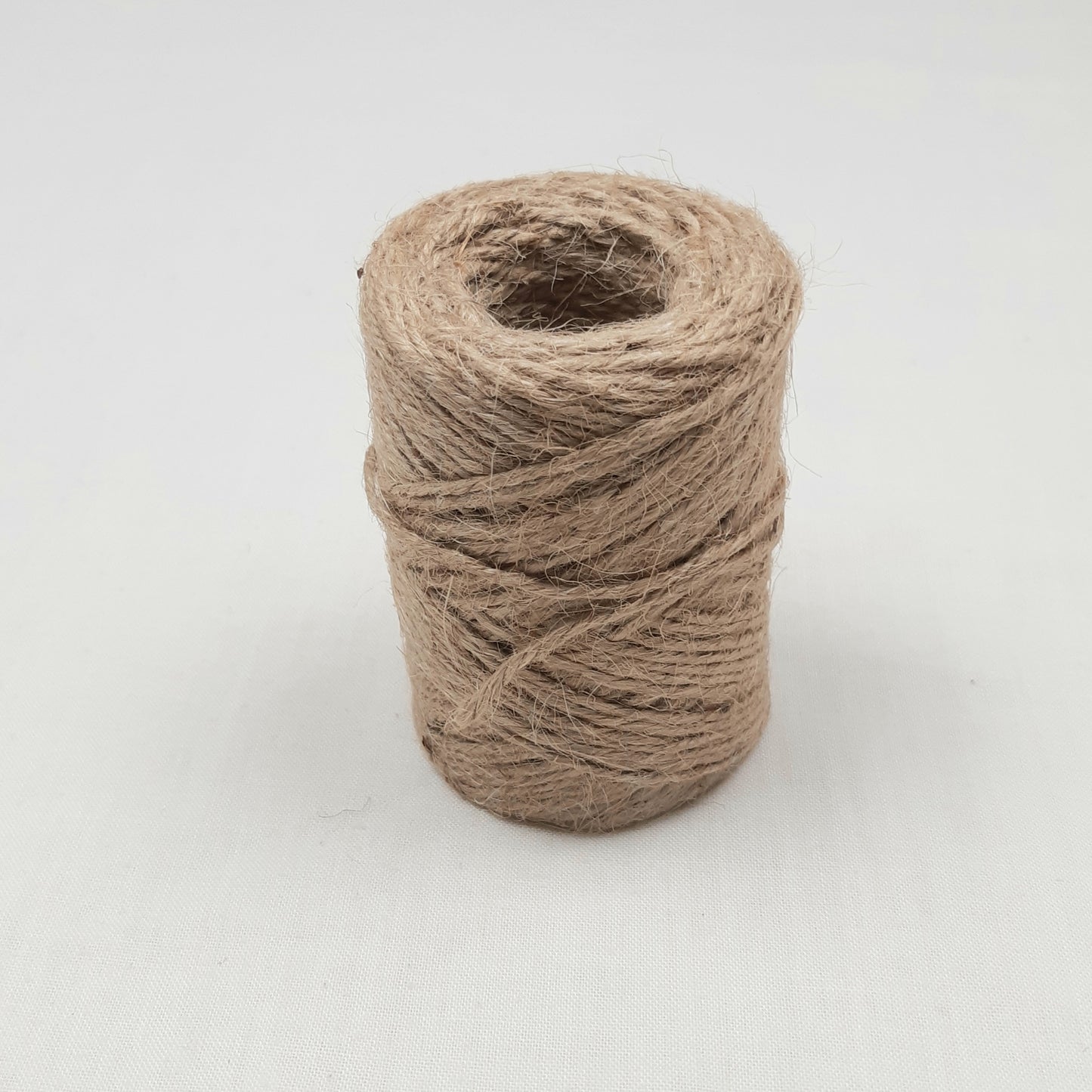 A roll of Natural Brown Jute Mossing Twine for crafting and floristry.