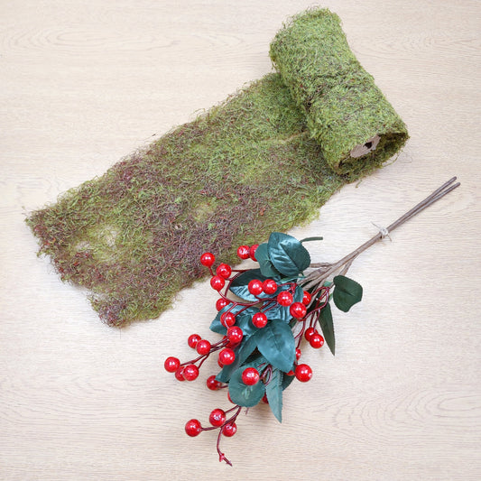 Faux Red and Green Moss and a Bundle of Faux Berries against a wooden background