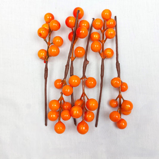 A pack of 6 faux orange berry picks, on a white background