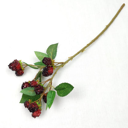 Artificial blackberry stem with green leaves on a white background