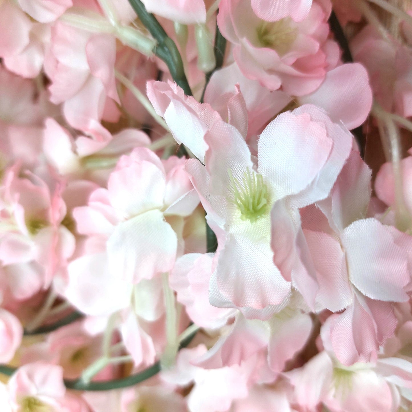 Close-up of artificial pink and white cherry blossom flowers with a soft focus background