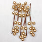 Gold berry picks on a white background