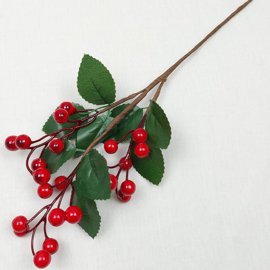 Faux Red Berries with Green Leaves on a pick against a white background