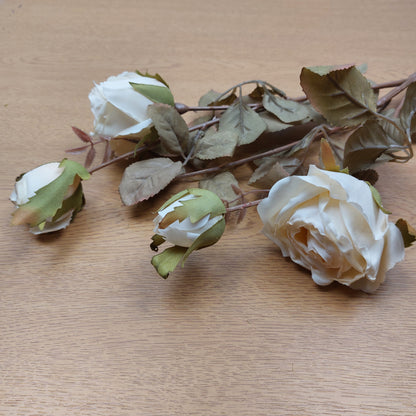 Artificial Cream Cabbage Rose bunch laying on a wooden surface