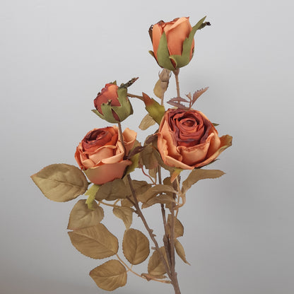 A faux dried look orange cabbage rose spray with multiple leaves, designed for use as a decorative floral arrangement component.