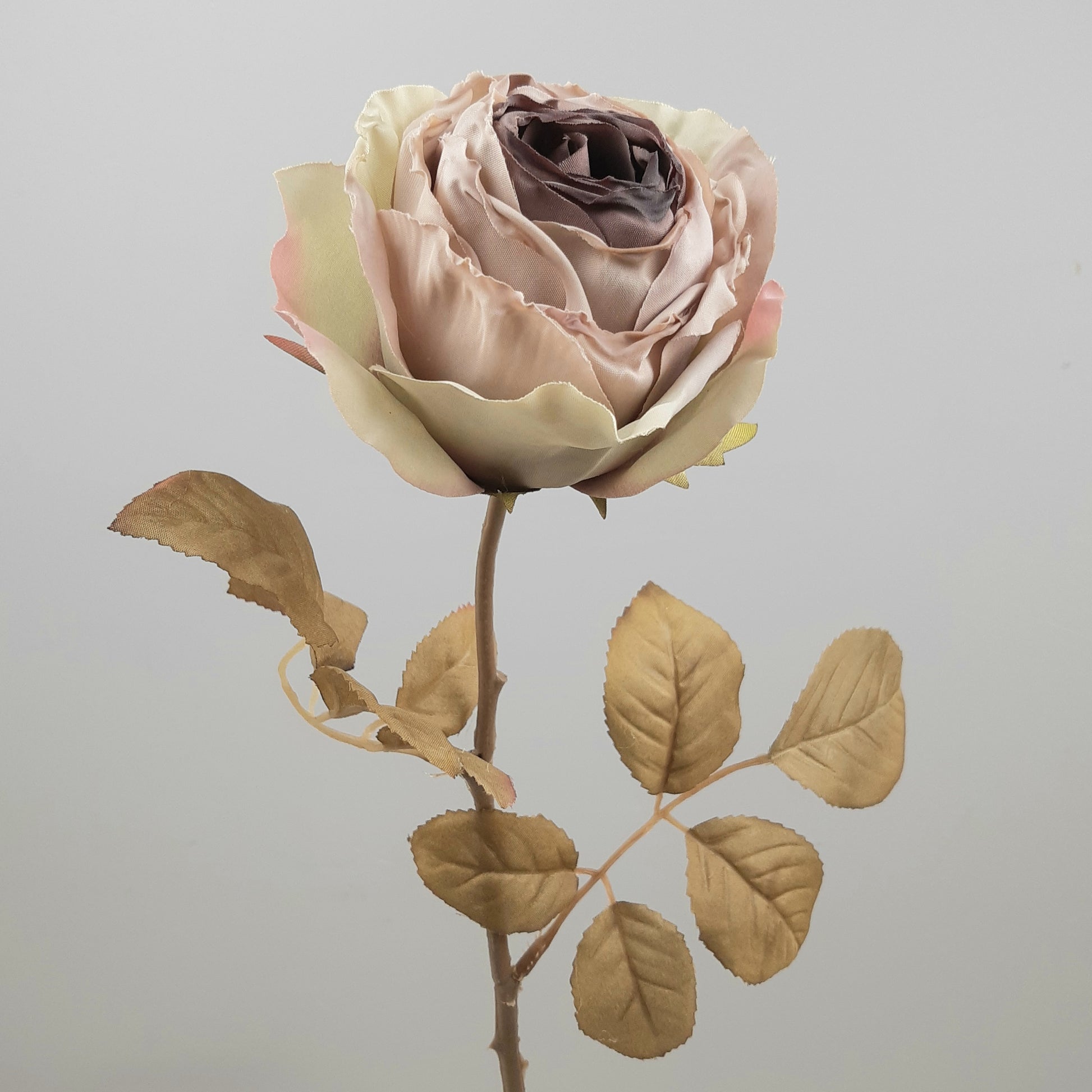 Artificial mauve-colored rose stem with dried look leaves, 68cm in length.