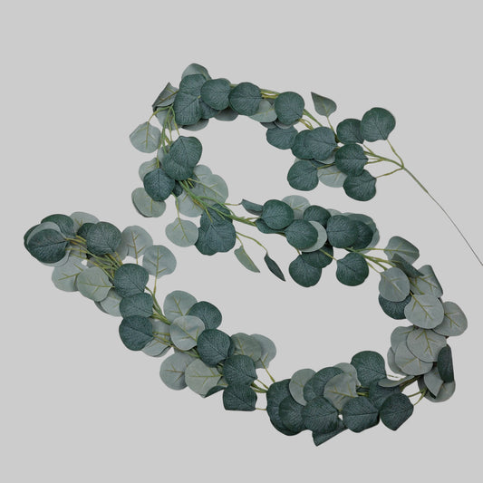 Artificial eucalyptus garland on a light gray background