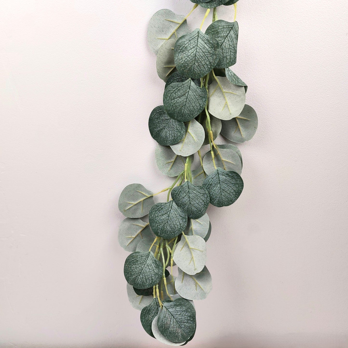 Artificial eucalyptus leaf garland on a light background