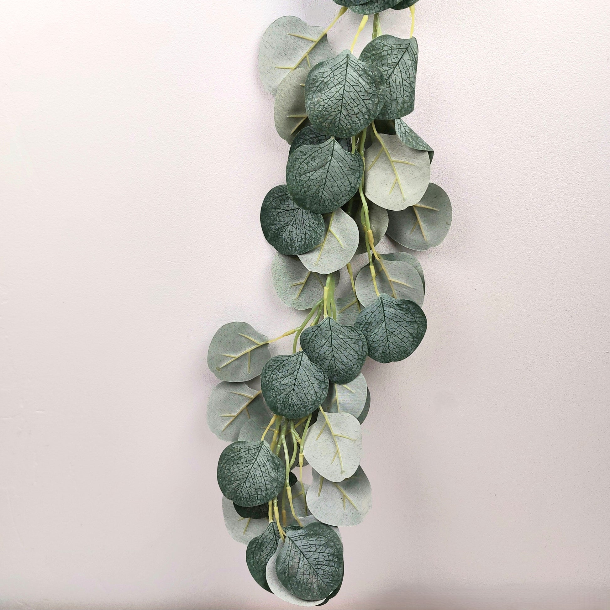 Artificial eucalyptus leaf garland on a light background