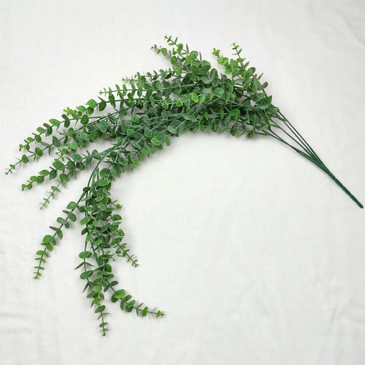 Artificial Green Hanging Eucalyptus branch against a white background