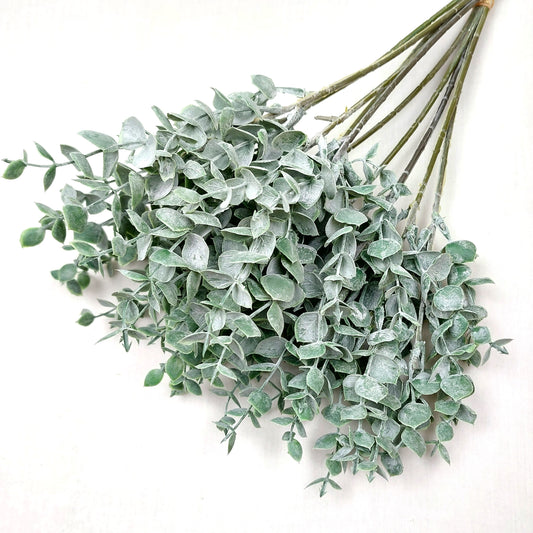Artificial Green Eucalyptus Springs against a white background 