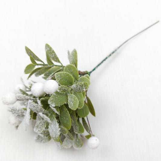 Artificial Mistletoe with white berries against a white background