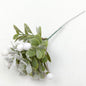 Artificial Mistletoe with white berries against a white background