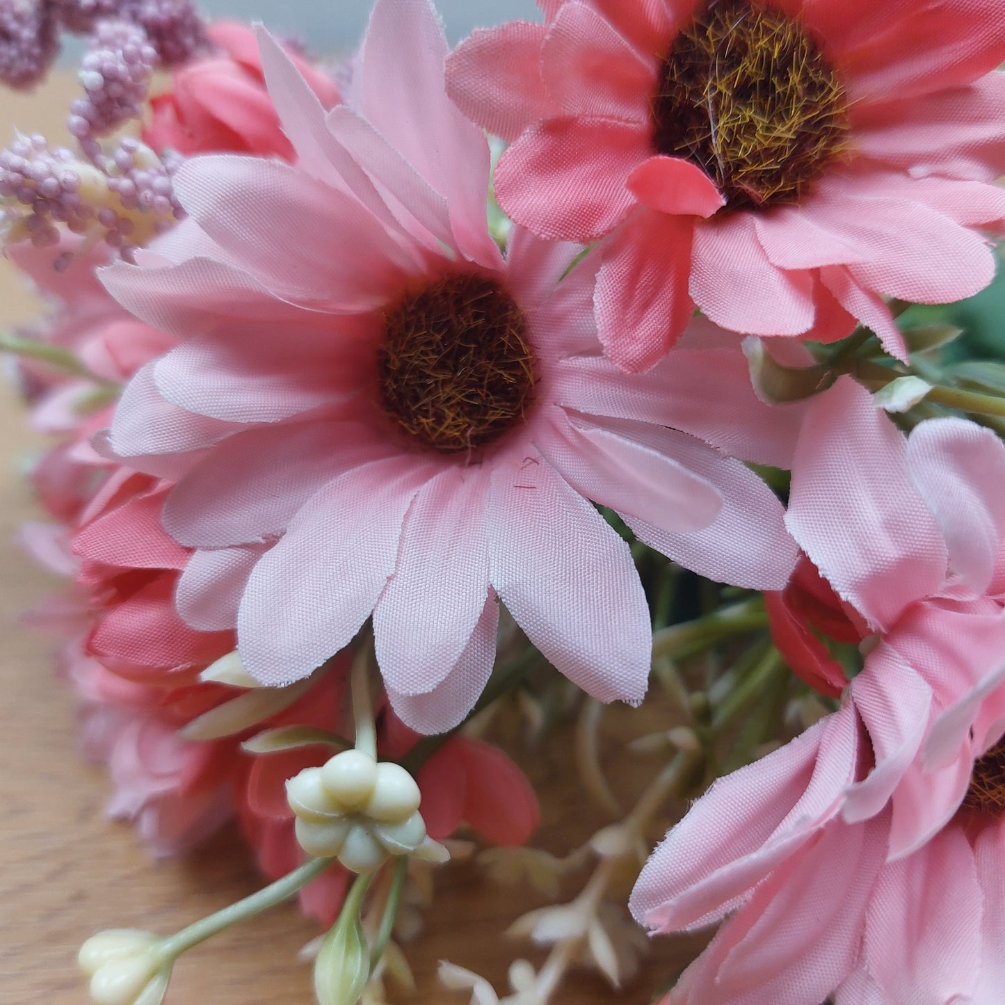 A close of artificial Gerbera Daisy flowers and other buds