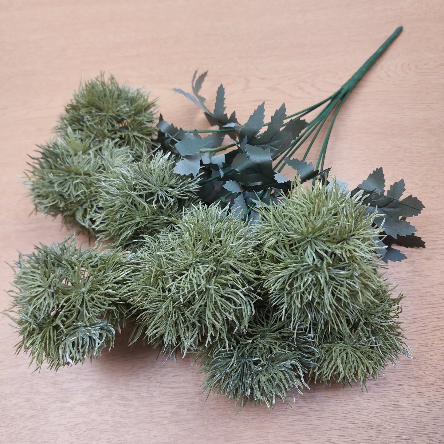 Green artificial Dianthus Green Trick plants on a wooden surface