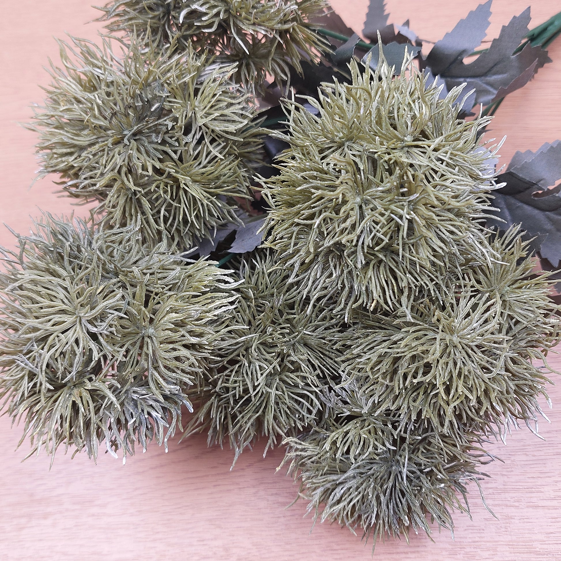 Artificial Green Trick Dianthus Pom Pom bush with a wooden background