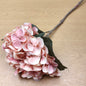 Artificial Pink hydrangea flower on a wooden surface