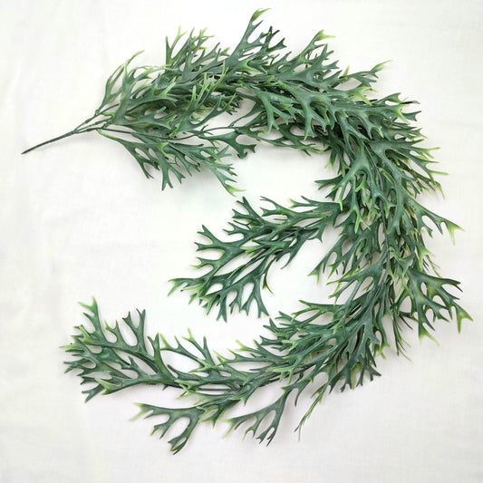 Artificial greenery hanging kelp seaweed on a white background