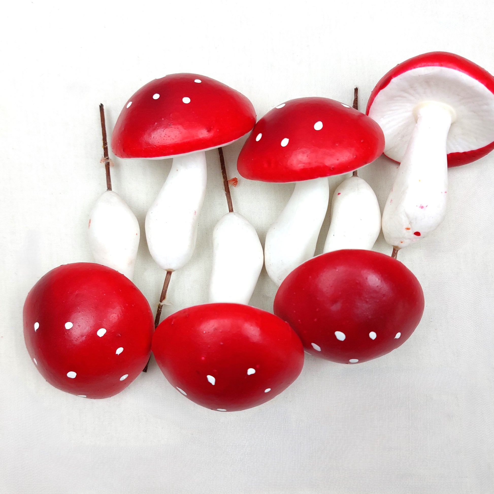 Artificial Red and white Mushrooms on a white background