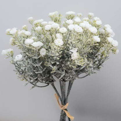 A bunch of artificial white gypsophila flowers with green foliage, tied together.