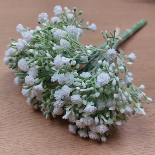 A bunch of artificial White Gyp laying down against a wooden background
