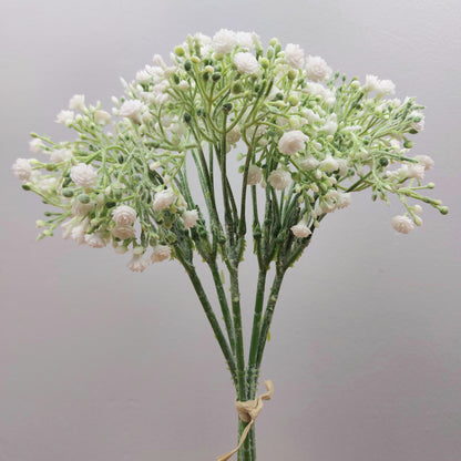A bunch of Artificial White Gyp with a mix of open flowers and buds, made up of 6 stems against a pale background