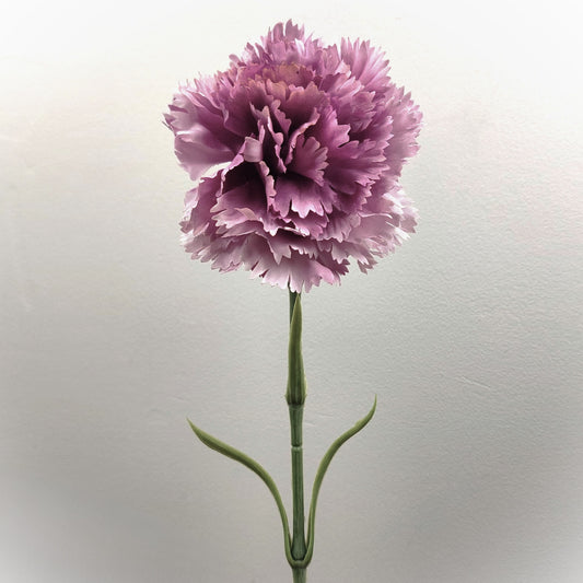 An artificial Lilac Ruffled Carnation flower with a green leafy stem against a pale background.