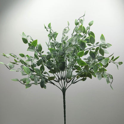 An artificial green leafy ruscus plant with multiple stems and oval-shaped leaves, shown against a plain light gray background.