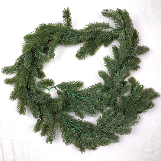 Artificial Green Spruce Garland on a white background