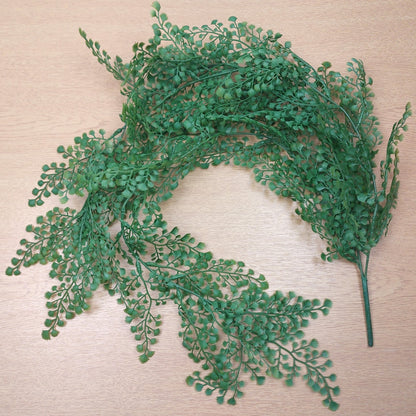Artificial Green Maidenhair Vine leafy branch on a wooden background