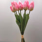 A bunch of artificial Pink Tulips against a pale background