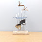 Decorative ornament with a fish design on a wooden base against a light gray background