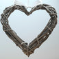 A hanging Grey Colour Wicker Heart with a white satin ribbon and bow.