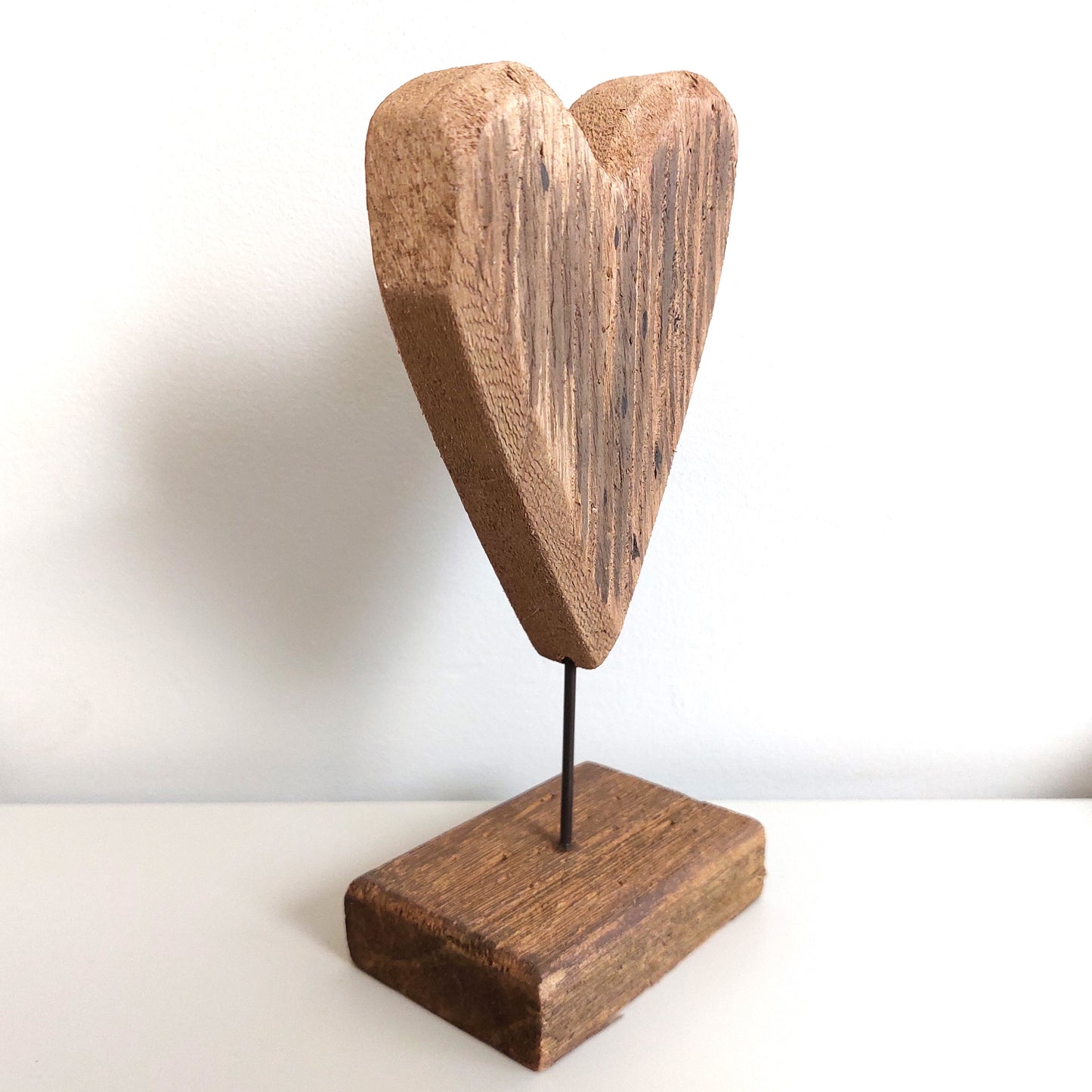 Angled Wooden heart-shaped sculpture on a white background