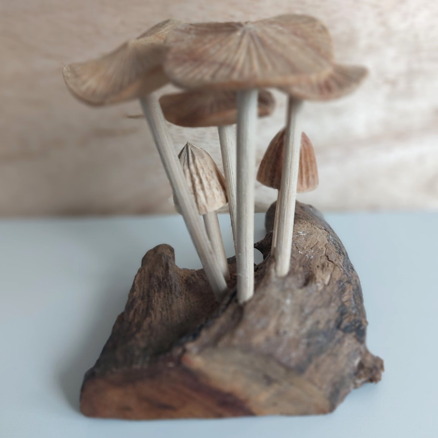 Hand Carved Wooden mushroom sculpture on a natural wood base