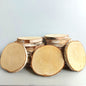 Stack of wooden birch log slices on a light gray background