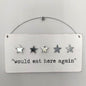 Decorative white wooden sign with five stars and text 'would eat here again' on a white background