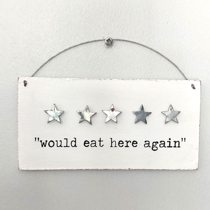 Five-star rating sign with 'would eat here again' text on a white background