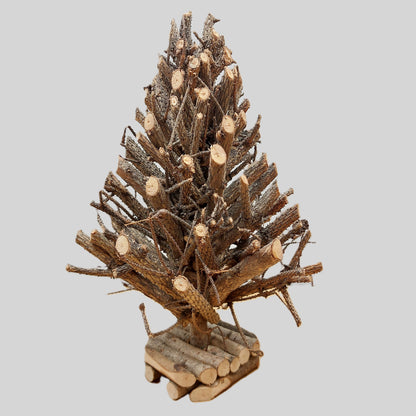 Decorative tree made of wooden branches on a gray background