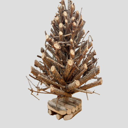 Decorative Christmas tree made of wooden branches on a light gray background