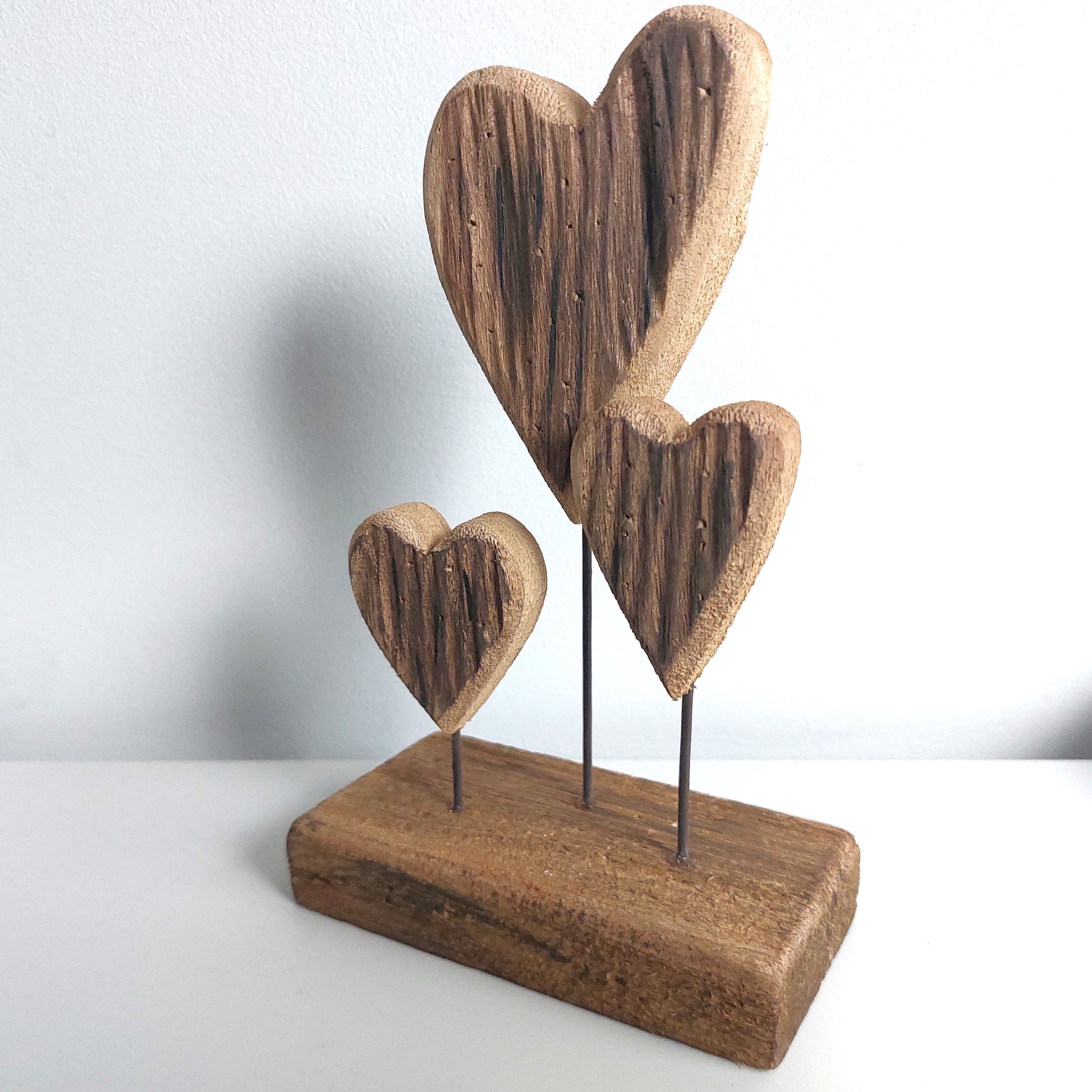 Wooden trio heart-shaped decorative piece on a white background