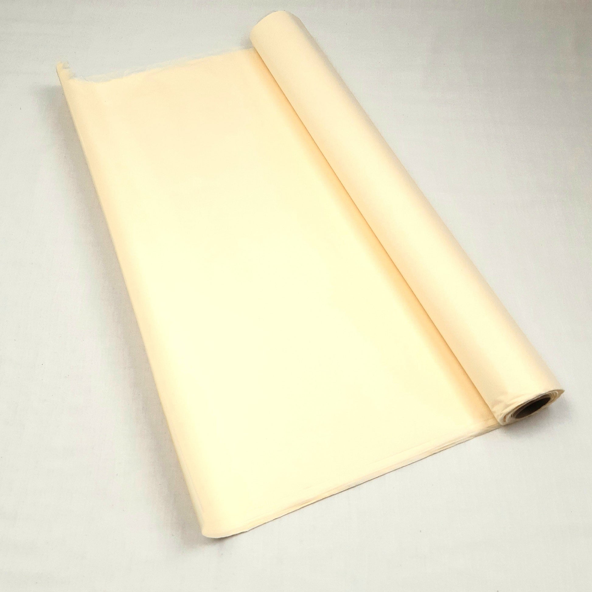 A roll of Ivory tissue paper against a grey background