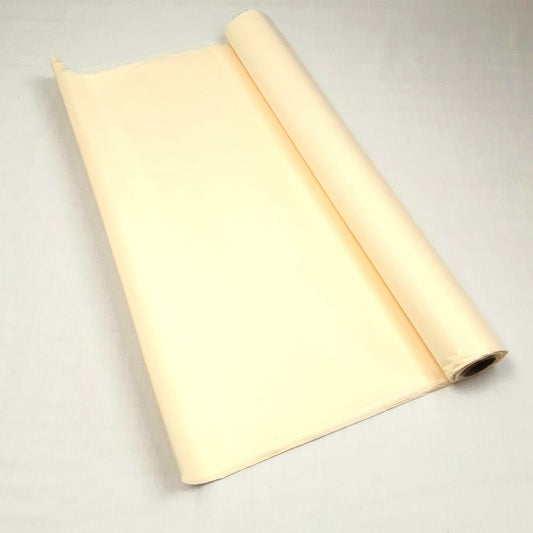A roll of Ivory tissue paper against a grey background