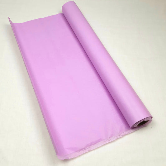 Rolled-up purple tissue paper on a light beige background