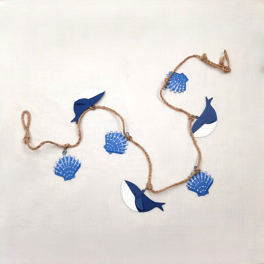 Decorative string with blue whale and shell shapes on a white background