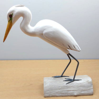 White Egret Wader bird figurine on a wooden base against a plain background